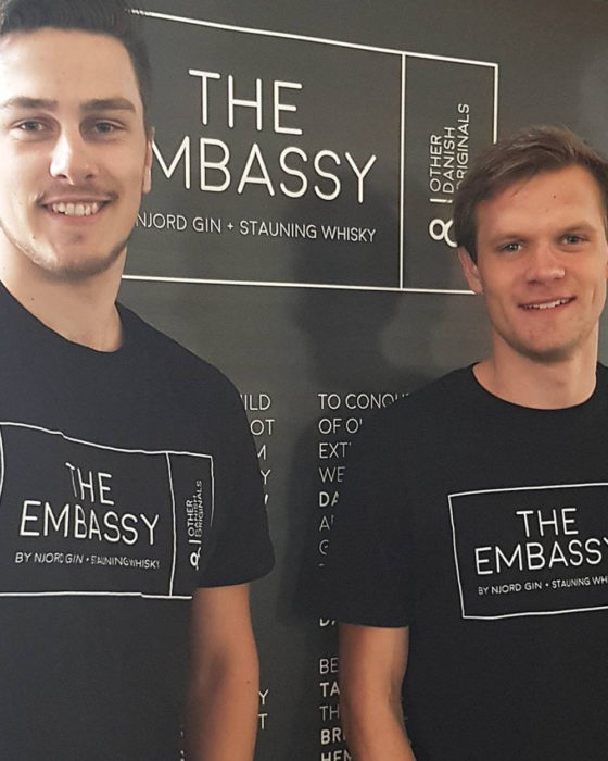 two bartenders in black t-shirts with logo design